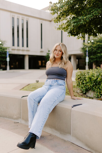 Bride standing on a bridge having wedding portraits done
