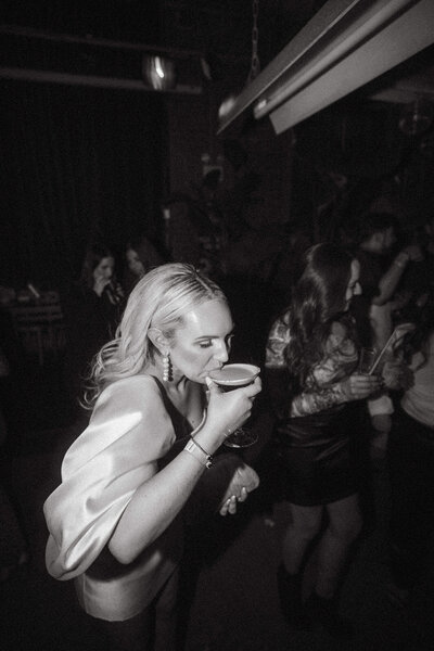 bride drinking on dance floor