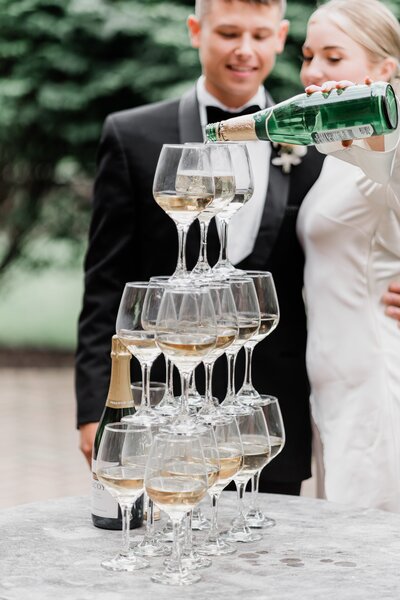 bride pouring champagne in a champagne tower