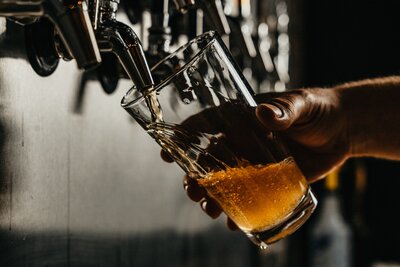 beer being poured from a tap