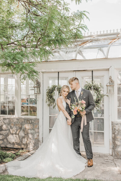Wedding Photographer & Elopement Photographer, bride and groom standing next to greenhouse