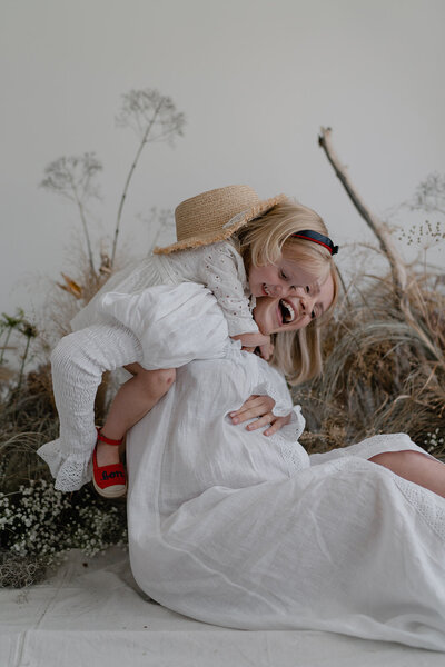 Pregnant mother sitting for a studio photoshoot