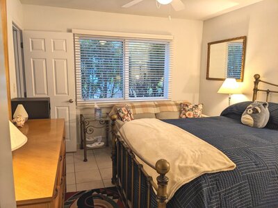 bedroom with warm lighting and blue bedding