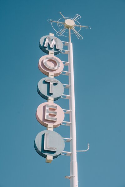 a retro motel sign in muted pastel colors on the contact page of socialfizz