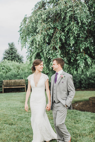 Wedding Photographer & Elopement Photographer, bride and groom walking through the grass
