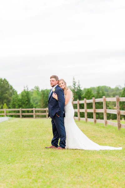 Bride and groom posing in the outdoor space at Southern Grace Farms, a wedding and event venue in Angier, North Carolina.
