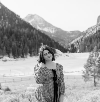 woman smiling in fall leaves