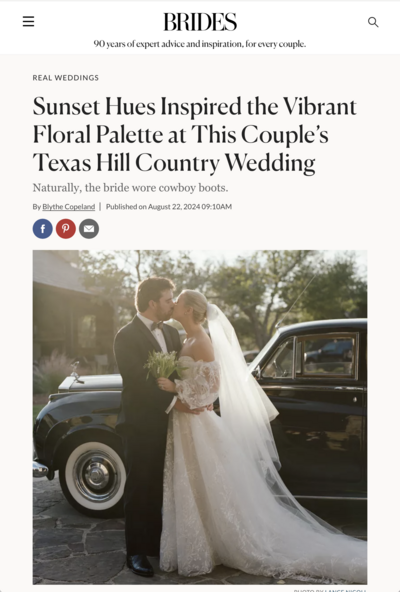 Bride and groom embrace in front of a classic car, with the bride wearing an off-the-shoulder lace gown and veil. The scene is outdoors and part of a feature on a Texas Hill Country wedding.