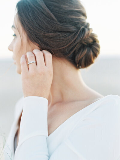 Kohnur classic bride in a sleek satin gown with a soft glam updo and sweetheart neckline