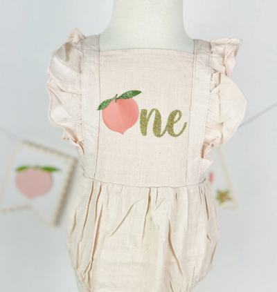 Peach birthday romper with peach and one on front