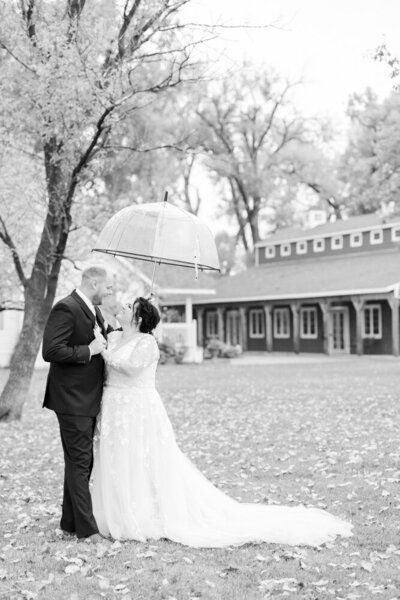 black and white wedding portrait of couple in the rain