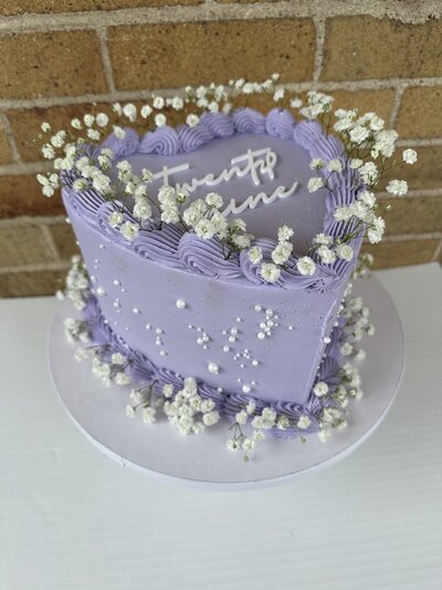 Adorable heart-shaped cakes from Icing on the Cake Bakery, beautifully decorated with frosting and perfect for any sweet celebration.