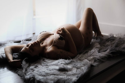 Woman posing for maternity boudoir photoshoot in Nashville TN