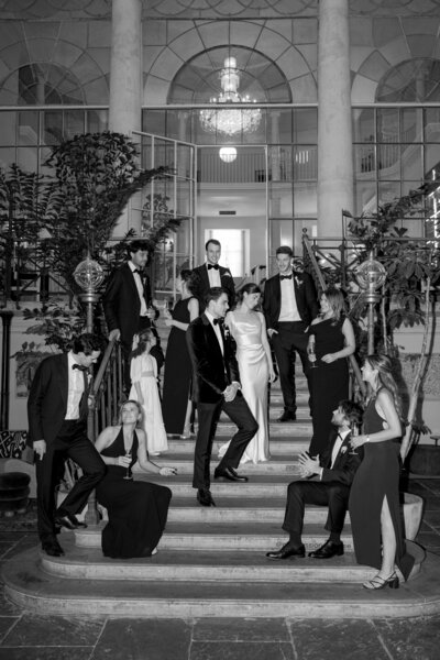 Group shot of wedding party gathered on the grand staircase.