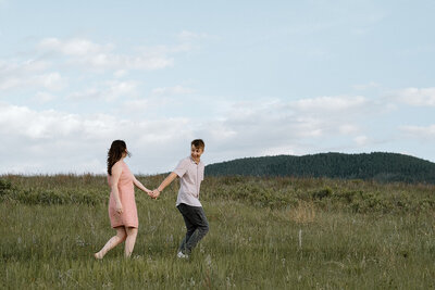 bride and groom kiss in front of chapel on the rock in Rocky Mountain National Park