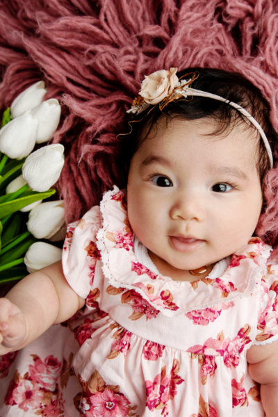 Baby girl photo session wearing a dress with flowers