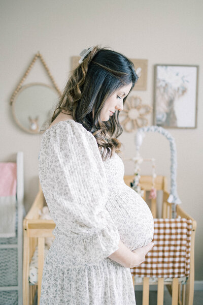 pregnant women holding belly and looking down at bump knoxville tennessee newborn photographer