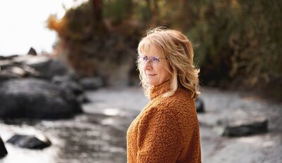 Lucie Zettel, orange jacket, headshot