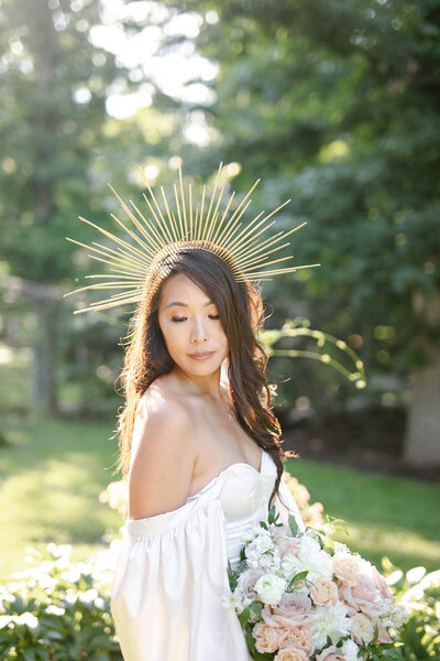 Girl stands with sun crown in a luxury garden