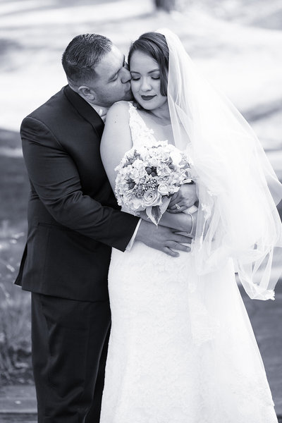 romantic photo of groom kissing bride