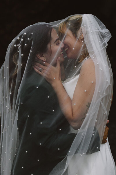brides kiss under veil