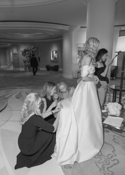 The bridesmaids helped bustle the bride's stunning gown.