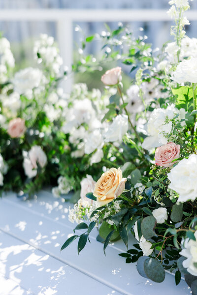 flowers on a white deck with the sun shining
