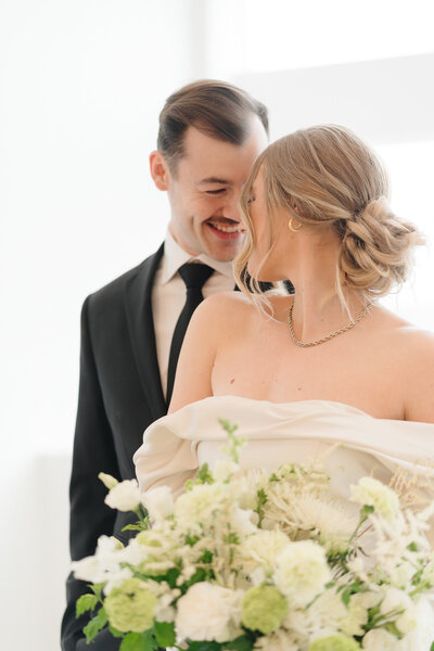 Bride and groom looking at each other as they walk up the stairs