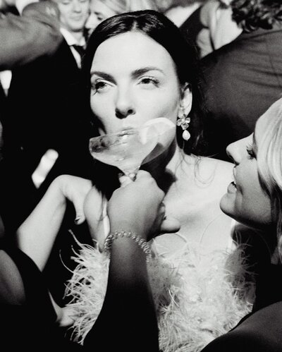 bride drinking on wedding day by luxury wedding photographer photographer Noble Photo Co