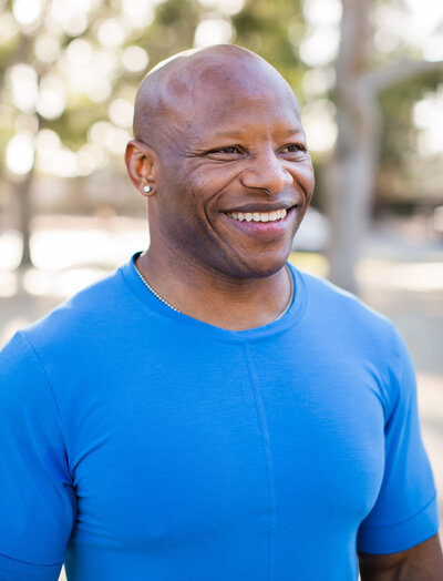 smiling man in blue shirt