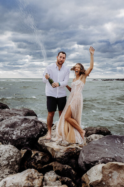 couple on rocks celebrating their florida beach elopement