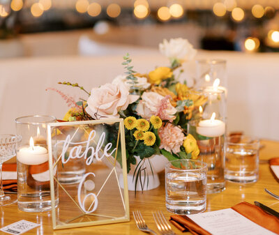 Colourful, Spring inspired wedding reception tablescape with pinks, peach, and tangerine hues, designed by Melissa Dawn Event Designs, wedding planner in Calgary, Alberta, featured on the Brontë Bride Vendor Guide.