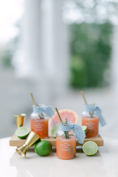 Bespoke signature drink in orange with lime and straw in palace Coburg Vienna