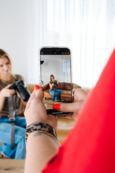 photographer standing and holding computer
