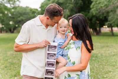 St. George maternity photographer photos with toddler, mom and dad holding ultrasound picture