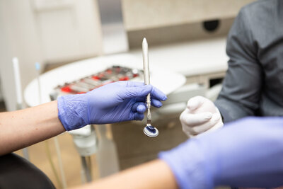 Prosthodontist performing a dental crowns procedure at Peak Prosthodontics in Lethbridge, Alberta to restore tooth strength and function.
