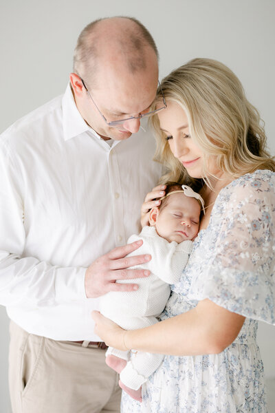 parents embracing their newborn baby