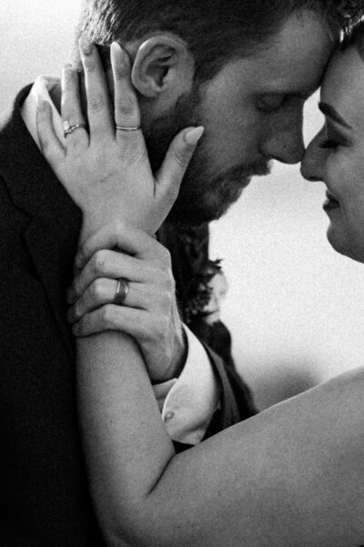 Bride and groom nuzzling in close