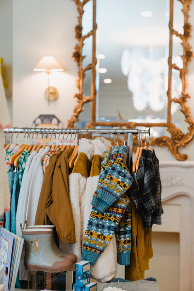 Photo of a clothing rack full of children's clothing featured in the window at Dalhouse boutique in Raleigh NC | Sara Coffin Photo