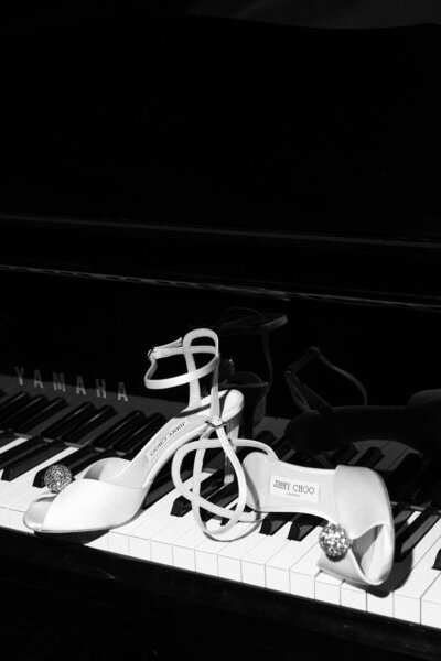 bride's Jimmy Choo high heels on a grand piano at the Rosecliff Mansion in Newport RI, by Andrea-Marie Photography