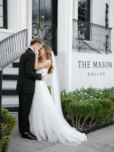 Bride and groom sharing an intimate moment outside The Mason Dallas after their wedding ceremony.