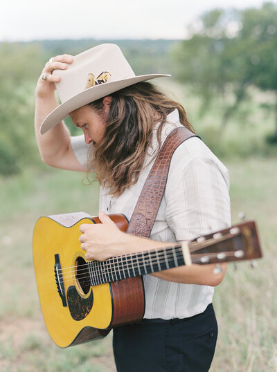 Mikaela Kahn's husband Jordan holding a guitar