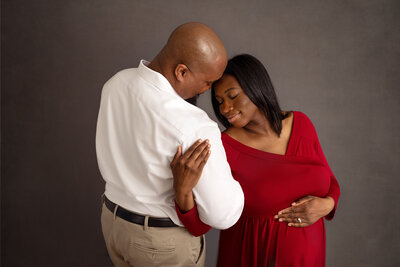 pregnant couple cuddling in studio by PHILADELPHIA MATERNITY PHOTOGRAPHER