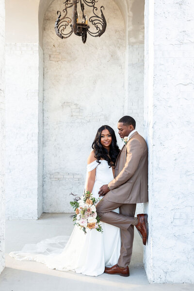 Couple taking portraits with Trilogy Design Group FLorals at Howe Farms.