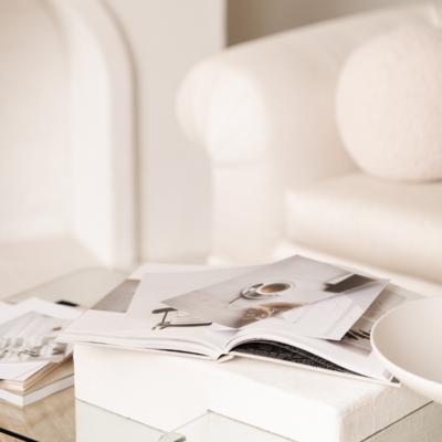 Open magazine on styled coffee table representing brand identity and content strategy services from The Agency

