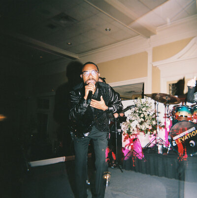 A wedding day photo of a singer during the wedding reception