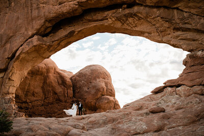 Couple embrace on a cliff