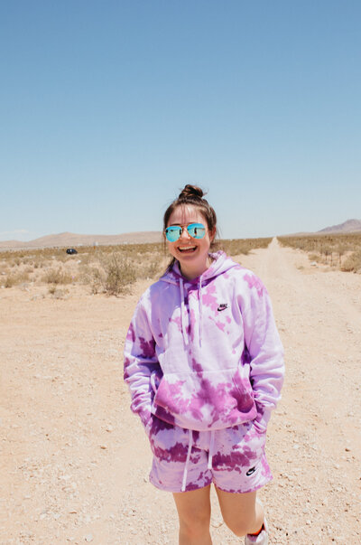 Girl in purple hoodie smiling.