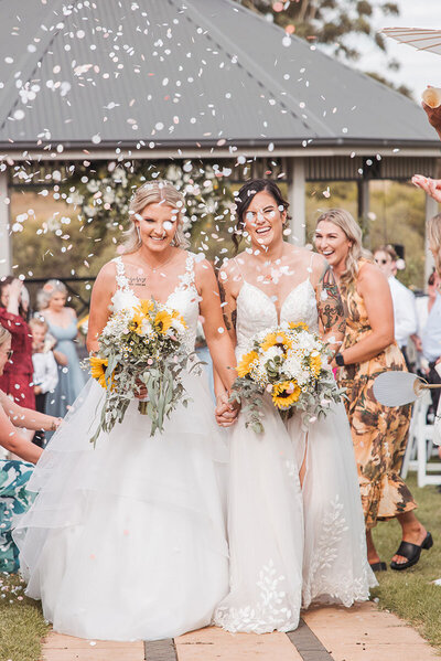 Two women walking down the aisle
