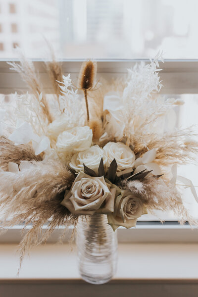 Wedding photo of bouquet sitting in front of window